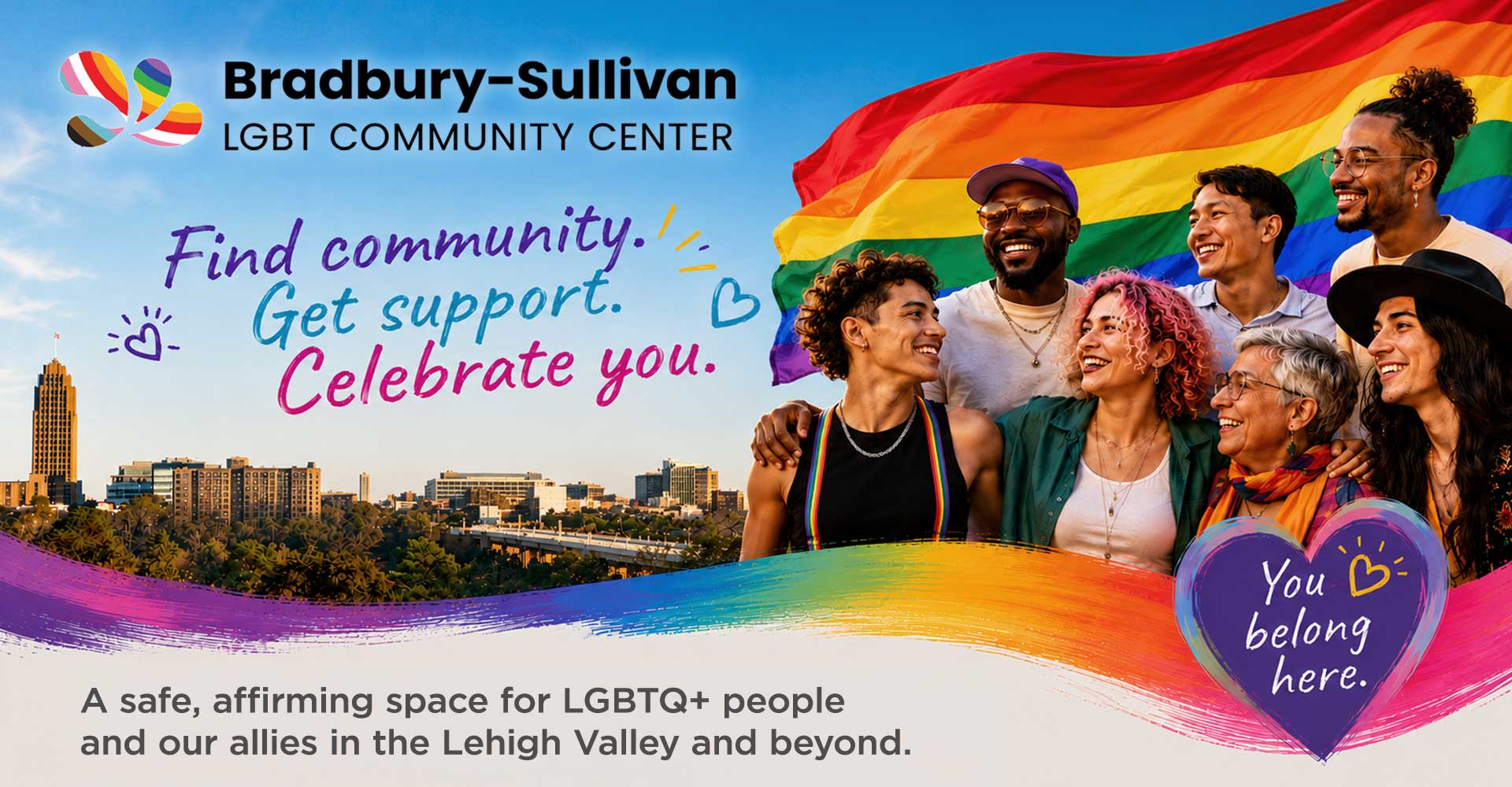 Diverse LGBTQ+ community members celebrating together in front of a rainbow Pride flag and the Allentown skyline. Bradbury-Sullivan LGBT Community Center – Find community. Get support. Celebrate you.